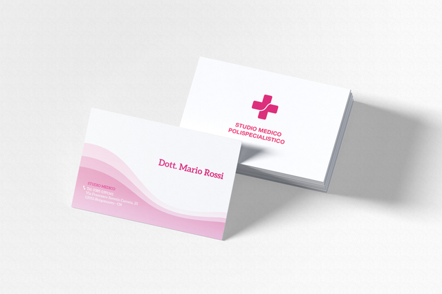 Due biglietti da visita medici bianchi personalizzati con grafica a onda rosa — uno con i dati di contatto di 'Dott. Mario Rossi' e l'altro con croce medica rosa e il brand 'Studio Medico Polispecialistico'. I biglietti da visita personalizzati per medici, cliniche e specialisti trasmettono professionalità e rendono facile per i pazienti conservare i riferimenti del loro medico.