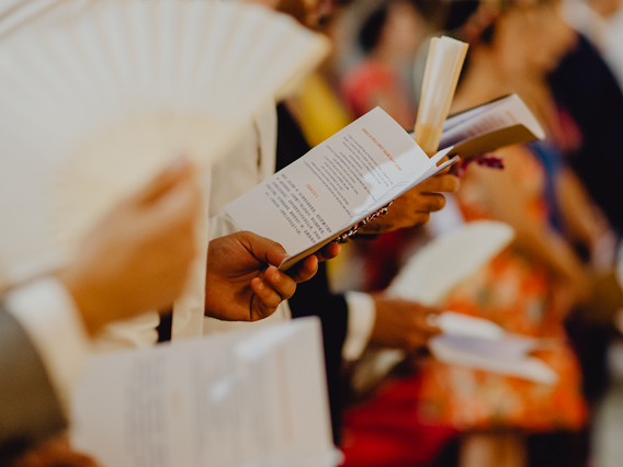 Un elegante libretto di matrimonio stampato tenuto da un ospite durante il ricevimento. Questi libretti matrimoniali personalizzati servono come ricordi e guide di riferimento per i tuoi ospiti durante la celebrazione. Perfetto per visualizzare i dettagli della cerimonia, i tempi e i momenti speciali in un formato stampato professionale.