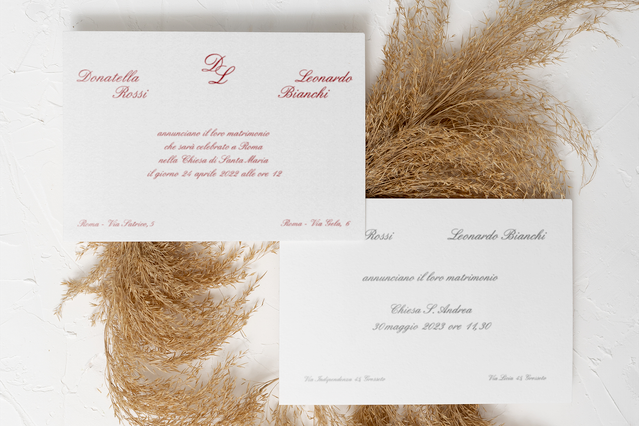 Elegante set di partecipazioni matrimonio classiche con due cartoncini con calligrafia rossa su fondo bianco, decorati con erba di pampa essiccata. La tipografia raffinata e il design minimalista rendono queste partecipazioni stampate senza tempo ed eleganti. Ideale per coppie che cercano partecipazioni matrimonio classiche.
